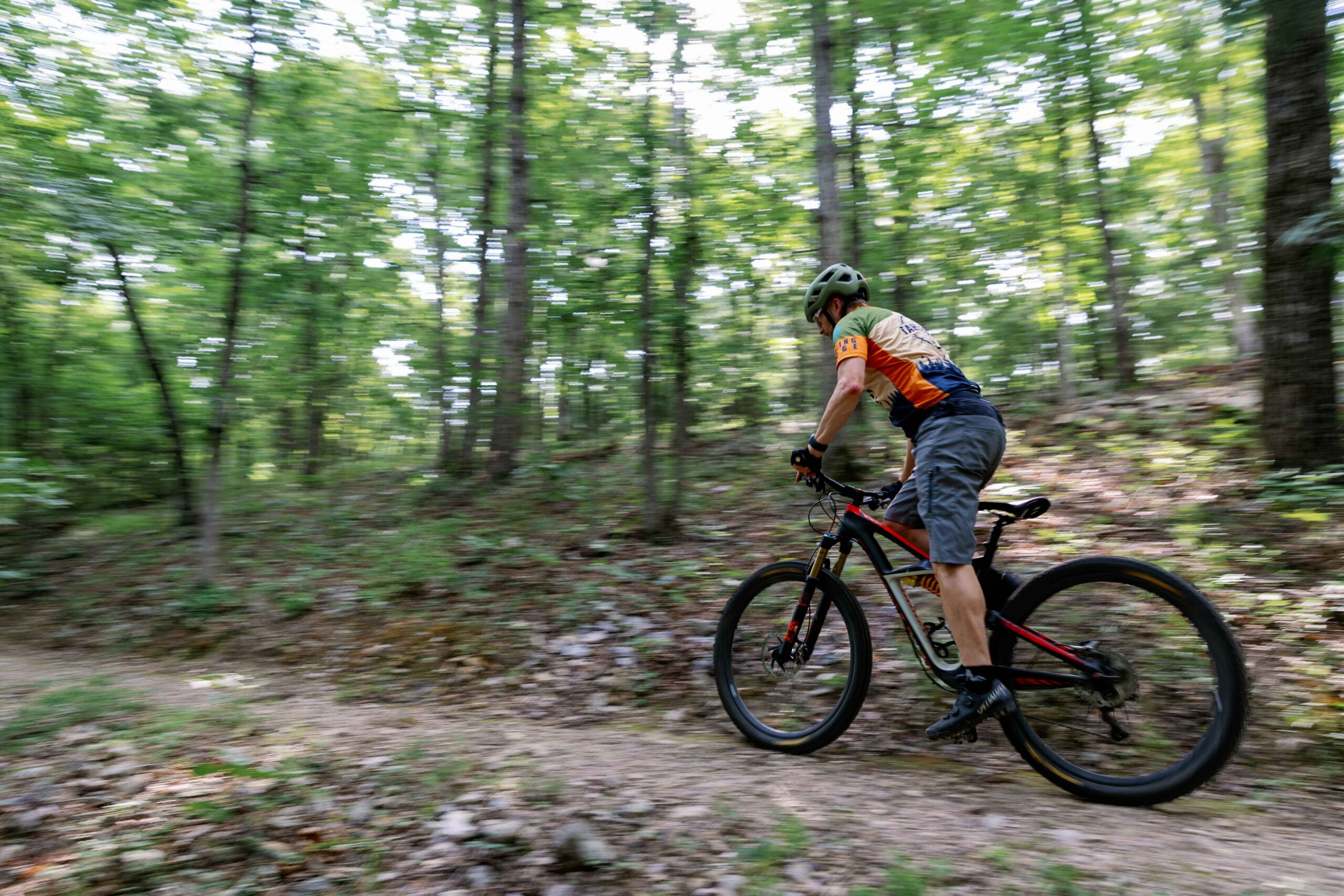 Mountain biker riding a wooded singletrack at Welling Ridge Trails